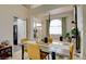 Bright dining room featuring a stylish table setting, hardwood floors, and a view into the living space at 4615 Stearman Dr, North Las Vegas, NV 89031