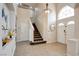 Elegant foyer with tile flooring, staircase, and soaring ceilings offers a grand entrance at 4615 Stearman Dr, North Las Vegas, NV 89031