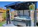 Inviting hot tub nestled in a gazebo with ambient lighting and decorative plants for relaxation at 4615 Stearman Dr, North Las Vegas, NV 89031