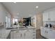 Updated kitchen offering granite counters, island with seating, and seamless flow to the living area at 4615 Stearman Dr, North Las Vegas, NV 89031