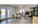Open living room with tile flooring, fireplace and access to outdoor seating at 4615 Stearman Dr, North Las Vegas, NV 89031