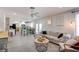 Open-concept living area with modern furnishings, a cozy couch, and a stylish kitchen in the background at 4615 Stearman Dr, North Las Vegas, NV 89031