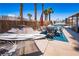 Spacious backyard featuring a pool, hammock, lounge area, and mature palm trees at 4742 Monterrey Ave, Las Vegas, NV 89121