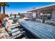 Outdoor dining area with a fireplace, overlooking the pool and backyard at 4742 Monterrey Ave, Las Vegas, NV 89121