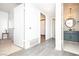 Hallway features grey hardwood flooring, white closets, and a view of the bathroom at 4742 Monterrey Ave, Las Vegas, NV 89121