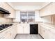 Bright kitchen with white cabinets, neutral countertops, and outdoor view at 4742 Monterrey Ave, Las Vegas, NV 89121