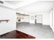 Open-concept living room with painted fireplace and gray wood flooring at 4742 Monterrey Ave, Las Vegas, NV 89121