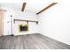 Bright living room featuring a stone fireplace, wood beams, and gray flooring at 4742 Monterrey Ave, Las Vegas, NV 89121