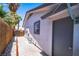 Side exterior featuring a walkway, a side door, and privacy landscaping for added seclusion at 4742 Monterrey Ave, Las Vegas, NV 89121