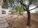 The backyard has a stone walkway and desert landscaping at 4821 Whisper Lake Ave, Las Vegas, NV 89131