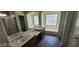 Bright bathroom with double sinks, shower, and tub under a large window at 4821 Whisper Lake Ave, Las Vegas, NV 89131