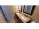 Bathroom featuring a double sink vanity with granite countertops and dark wood cabinets at 4821 Whisper Lake Ave, Las Vegas, NV 89131