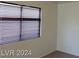 A bedroom with a window that has horizontal blinds allowing natural light at 4821 Whisper Lake Ave, Las Vegas, NV 89131