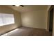 Bedroom featuring neutral walls, carpet flooring, ceiling fan and a window providing natural light at 4821 Whisper Lake Ave, Las Vegas, NV 89131