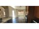 Kitchen area with dark cabinets, and views into the dining and living areas at 4821 Whisper Lake Ave, Las Vegas, NV 89131