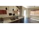 Modern kitchen with a view of the bright living room with a fireplace and large windows at 4821 Whisper Lake Ave, Las Vegas, NV 89131
