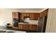 Kitchen with wooden cabinets, stainless steel appliances, and built-in oven at 4821 Whisper Lake Ave, Las Vegas, NV 89131