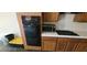 Traditional kitchen with oak cabinets and black appliances at 4821 Whisper Lake Ave, Las Vegas, NV 89131