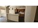 Open kitchen featuring wood cabinetry, breakfast bar, and modern hanging pendant lights at 4821 Whisper Lake Ave, Las Vegas, NV 89131