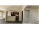 Open floor plan showcases the kitchen and living area with tile flooring and modern lighting at 4821 Whisper Lake Ave, Las Vegas, NV 89131
