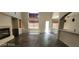This is an empty living room with tile flooring, a fireplace and many windows for natural light at 4821 Whisper Lake Ave, Las Vegas, NV 89131