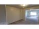 An open-concept living room features carpeted floors, neutral walls, and an open layout at 4821 Whisper Lake Ave, Las Vegas, NV 89131