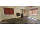 Spacious living room with dark tile flooring, a fireplace, and multiple windows at 4821 Whisper Lake Ave, Las Vegas, NV 89131
