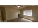 The main bedroom with carpeted floors, ceiling fan, and a glimpse into the attached bathroom at 4821 Whisper Lake Ave, Las Vegas, NV 89131