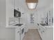 Charming kitchen featuring white cabinets, modern appliances, and ample natural light at 4843 S Torrey Pines Dr # 101, Las Vegas, NV 89103