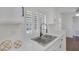 Well-lit kitchen featuring white cabinets, stainless steel sink, and modern faucet at 4843 S Torrey Pines Dr # 101, Las Vegas, NV 89103