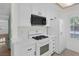 Bright kitchen with white appliances, tile floor, and ample cabinet space at 4843 S Torrey Pines Dr # 101, Las Vegas, NV 89103