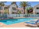 Community swimming pool with lounge chairs and a palm tree at 4843 S Torrey Pines Dr # 101, Las Vegas, NV 89103