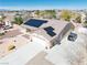 Aerial view of residence with solar panels, desert landscaping, three-car garage and extended driveway at 4910 Marywood Ct, Pahrump, NV 89061