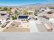 Aerial view of property with a three-car garage, solar panels, and mountain views in the distance at 4910 Marywood Ct, Pahrump, NV 89061