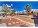 Backyard featuring custom desert landscaping with gravel, trees, and a brick pathway at 4910 Marywood Ct, Pahrump, NV 89061