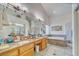 Elegant bathroom featuring granite countertops, double sinks, a soaking tub, and a separate glass-enclosed shower at 4910 Marywood Ct, Pahrump, NV 89061