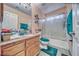 Bathroom with a granite countertop vanity, frosted shower doors, and matching blue accessories at 4910 Marywood Ct, Pahrump, NV 89061