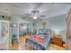Cozy bedroom featuring a ceiling fan, mirrored closet doors, and warm wood floors at 4910 Marywood Ct, Pahrump, NV 89061