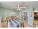 Cozy bedroom with wood-look flooring, a window, ceiling fan and neutral paint at 4910 Marywood Ct, Pahrump, NV 89061