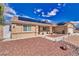 Inviting exterior featuring solar panels, desert landscaping, a well-maintained lawn, and a two-car garage at 4910 Marywood Ct, Pahrump, NV 89061