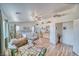 Bright, spacious main bedroom featuring wood floors, a ceiling fan, and a comfortable seating area with a chaise lounge at 4910 Marywood Ct, Pahrump, NV 89061