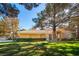 Spacious backyard features a lush lawn and mature trees, creating a peaceful outdoor space at 4911 Mount Pleasant Ln, Las Vegas, NV 89113