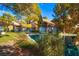 Charming home with water view featuring mature trees, manicured landscaping, and a private outdoor area at 4911 Mount Pleasant Ln, Las Vegas, NV 89113