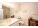 Well-lit bathroom with vanity, mirror, and shower with golden trim at 4911 Mount Pleasant Ln, Las Vegas, NV 89113