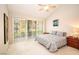 Bright bedroom with large windows offering serene views of the landscaped backyard and patio at 4911 Mount Pleasant Ln, Las Vegas, NV 89113