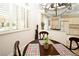 Cozy dining area with a round table, plantation shutters, and an adjacent open-plan kitchen at 4911 Mount Pleasant Ln, Las Vegas, NV 89113