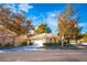 Inviting single-story home boasts mature trees, a two-car garage, and meticulously maintained landscaping at 4911 Mount Pleasant Ln, Las Vegas, NV 89113