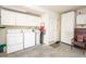Well-organized garage with storage cabinets and laundry area, providing ample space for vehicles at 4911 Mount Pleasant Ln, Las Vegas, NV 89113