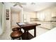 Bright kitchen with white cabinetry, granite countertops, and a wooden kitchen island with seating at 4911 Mount Pleasant Ln, Las Vegas, NV 89113