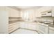 Updated kitchen featuring white appliances, granite countertops, white cabinets, and tile flooring at 4911 Mount Pleasant Ln, Las Vegas, NV 89113